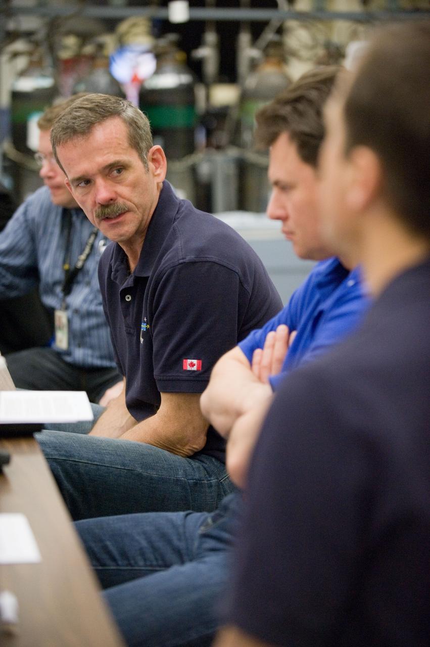 DATE: 3-22-12 LOCATION: Bldg. 9NW - ISS Mockups SUBJECT: Expedition 34 crew Chris Hadfield, Roman Romanenko and Tom Marshburn during emergency scenarios training in the ISS mockups with instructor Kathryn Bolt PHOTOGRAPHER: Lauren Harnett