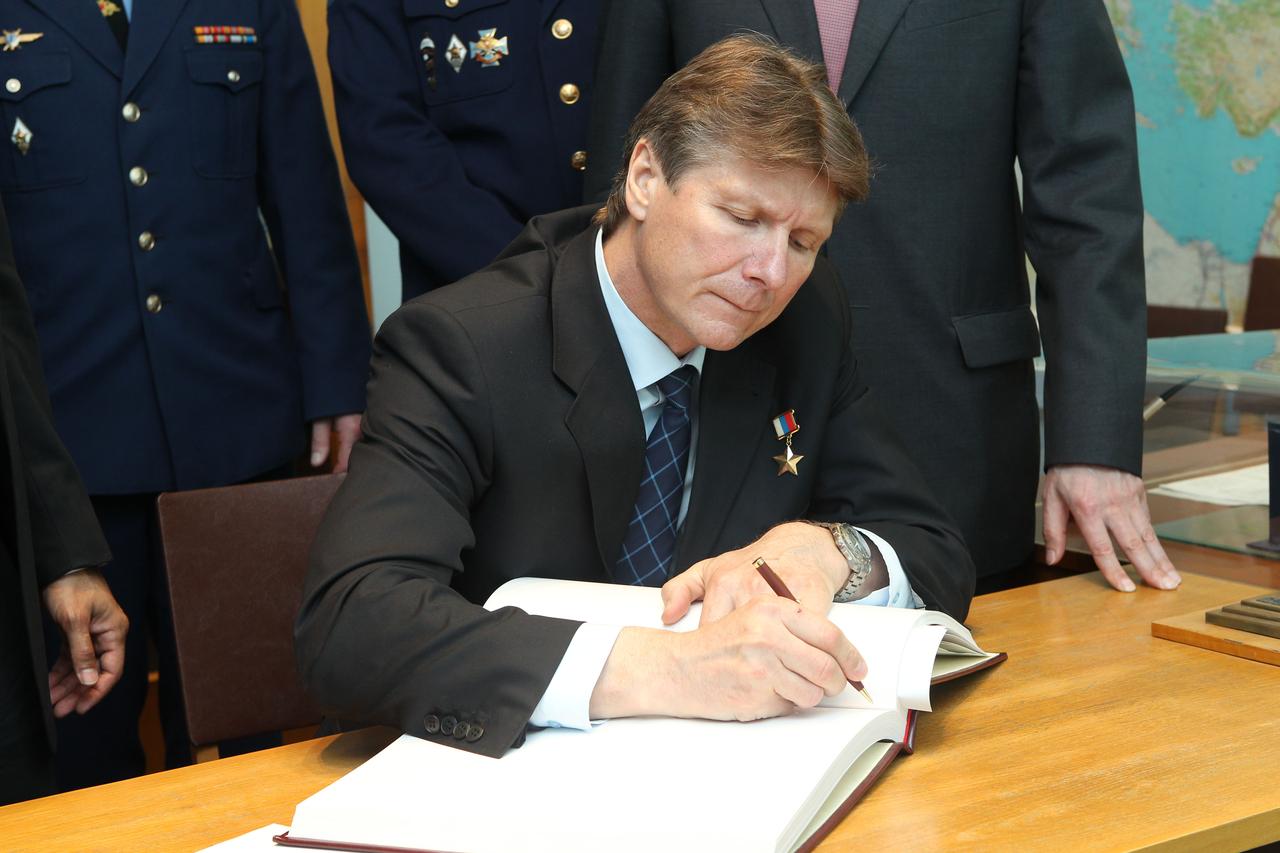 (25 April 2012) --- At the Gagarin Cosmonaut Training Center in Star City, Russia, outside Moscow, Expedition 31 Soyuz commander Gennady Padalka signs a traditional cosmonauts' log at the site's Yuri Gagarin museum. Padalka, along with NASA astronaut Joe Acaba, and cosmonaut Sergei Revin (not pictured) are preparing for the launch May 15 that will take them to the International Space Station on the Soyuz TMA-04M spacecraft from the Baikonur Cosmodrome in Kazakhstan. Photo credit: NASA/Stephanie Stoll