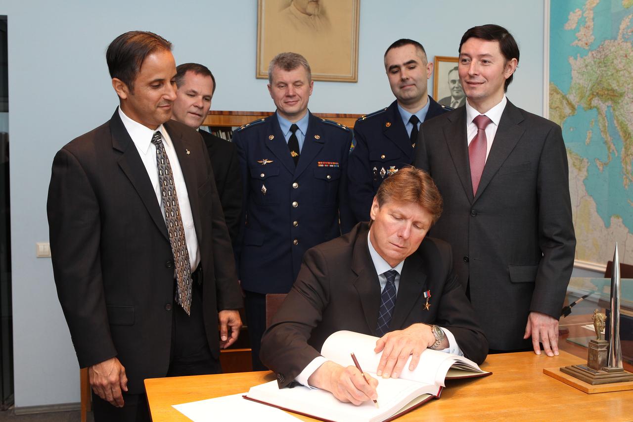 (seated), flanked by Expedition 31 prime and backup crewmembers, signs a traditional cosmonauts' log at the site's Yuri Gagarin museum. Front at left is NASA astronaut Joe Acaba, flight engineer, and at front row, right is Russian cosmonaut and flight engineer Sergei Revin. Back row,from left are Expedition 31 backup crewmembers Kevin Ford of NASA and Russian cosmonauts Oleg Novitskiy and Evgeny Tarelkin. Acaba, Padalka and Revin are preparing for the launch May 15 that will take them to the International Space Station on the Soyuz TMA-04M spacecraft from the Baikonur Cosmodrome in Kazakhstan. Photo credit: NASA/Stephanie Stoll