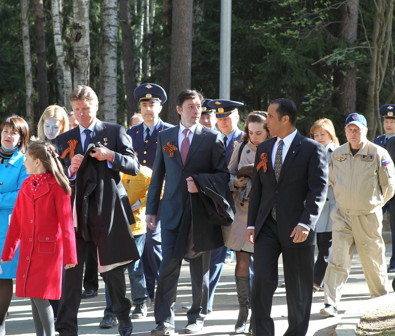 (2 May, 2012) --- At the Gagarin Cosmonaut Training Center at Star City, Russia on May 2, 2012, the prime crew members who will round out Expedition 31 on the International Space Station walk with their families to their farewell sendoff to the Baikonur Cosmodrome in Kazakhstan. From left to right are Soyuz Commander Gennady Padalka, Flight Engineer Sergei Revin, and NASA Flight Engineer Joe Acaba, all three wearing the Ribbon of St. George in honor of Russia’s Victory Day celebrations on May 9. The trio are scheduled to launch to the space station on May 15 in their Soyuz TMA-04M spacecraft.   NASA/Stephanie Stoll 