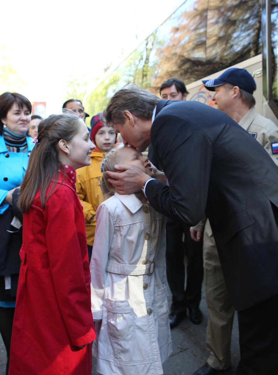 (2 May, 2012) --- At the Gagarin Cosmonaut Training Center at Star City, Russia on May 2, 2012, Expedition 31 Soyuz Commander Gennady Padalka kisses his granddaughter goodbye as his one of his daughters, left, looks on. Padalka, along with flight engineers Joe Acaba of NASA and cosmonaut Sergei Revin, flew to their launch site at the Baikonur Cosmodrome in Kazakhstan for final preparations for their launch to the International Space Station on May 15 in their Soyuz TMA-04M spacecraft.   NASA/Stephanie Stoll 
