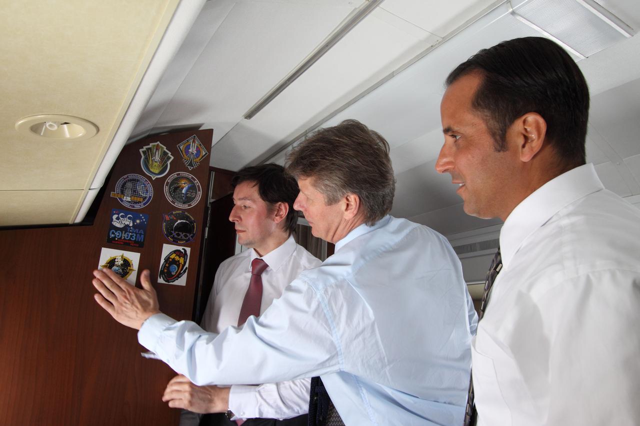 Aboard their Gagarin Cosmonaut Training Center plane that transported them from their training base in Star City, Russia to their launch site at the Baikonur Cosmodrome in Kazakhstan, the next trio of crew members that will be launched to the International Space Station take time out May 2, 2012 to affix their Soyuz crew patch sticker to the cabin of the aircraft. From left to right are Expedition 31/32 Flight Engineer Sergei Revin, Soyuz Commander Gennady Padalka and NASA Flight Engineer Joe Acaba. They will be launched to the station in their Soyuz TMA-04 spacecraft from Baikonur on May 15, Baikonur time. NASA/Victor Zelentsov