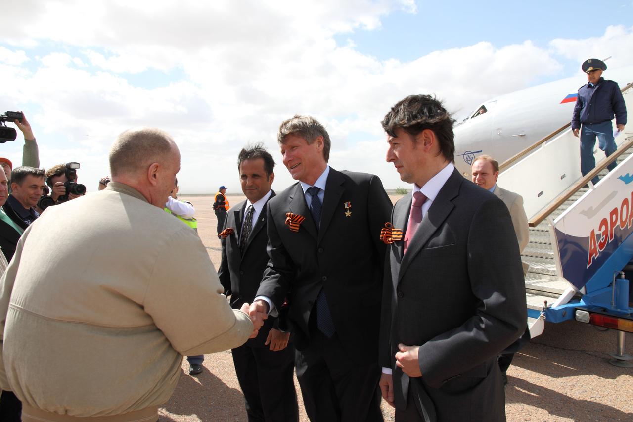 Expedition 31/32 Soyuz Commander Gennady Padalka (center) and his crewmates are greeted by Russian space officials upon their arrival in Baikonur, Kazakhstan May 2, 2012 after flying from their training base in Star City, Russia for final preparations for their launch May 15, Baikonur time, to the International Space Station on their Soyuz TMA-04M spacecraft. Joining Padalka are NASA Flight Engineer Joe Acaba (left) and Flight Engineer Sergei Revin.  NASA/Victor Zelentsov 