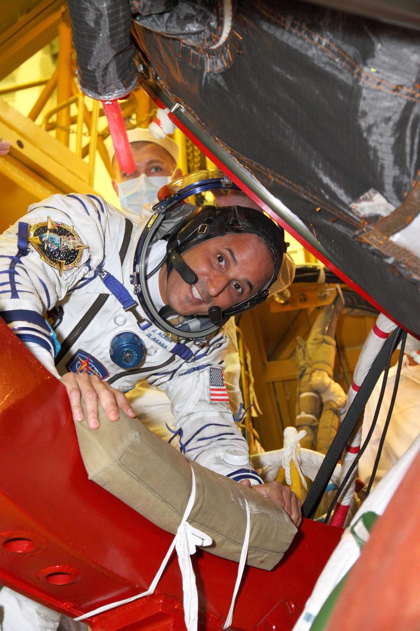 At the Baikonur Cosmodrome in Kazakhstan, Expedition 31/32 Flight Engineer Joe Acaba of NASA flashes a smile as he climbs aboard his Soyuz TMA-04M spacecraft May 3, 2012 during a suited “fit check” dress rehearsal of launch day activities in advance of his launch May 15 along with Soyuz Commander Gennady Padalka and Flight Engineer Sergei Revin to the International Space Station. Acaba, Padalka and Revin will spend four months aboard the orbital outpost.  NASA/Victor Zelentsov 