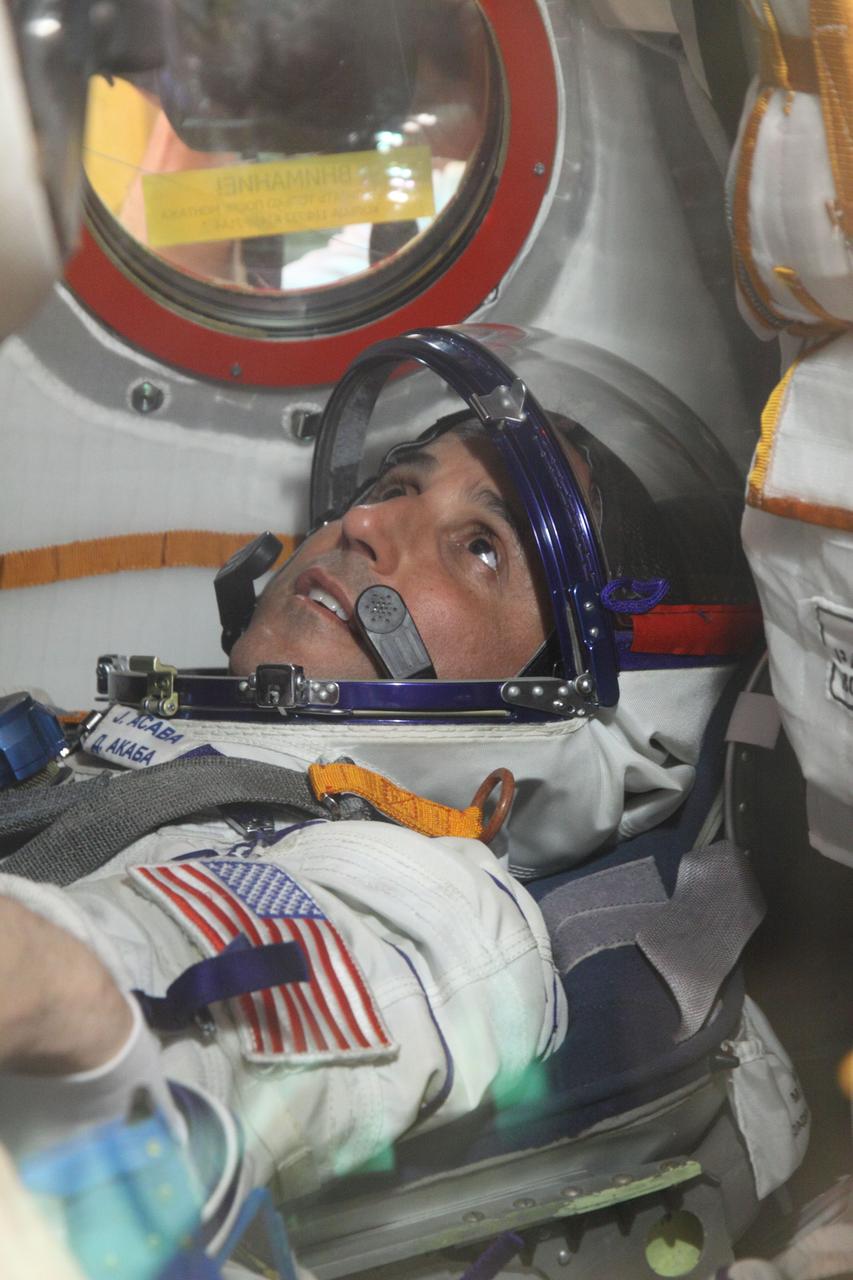 At the Baikonur Cosmodrome in Kazakhstan, Expedition 31/32 Flight Engineer Joe Acaba of NASA looks up at the control panel aboard his Soyuz TMA-04M spacecraft May 3, 2012 during a suited “fit check” dress rehearsal of launch day activities in advance of his launch May 15 along with Soyuz Commander Gennady Padalka and Flight Engineer Sergei Revin to the International Space Station. Acaba, Padalka and Revin will spend four months aboard the orbital outpost.  NASA/Victor Zelentsov 
