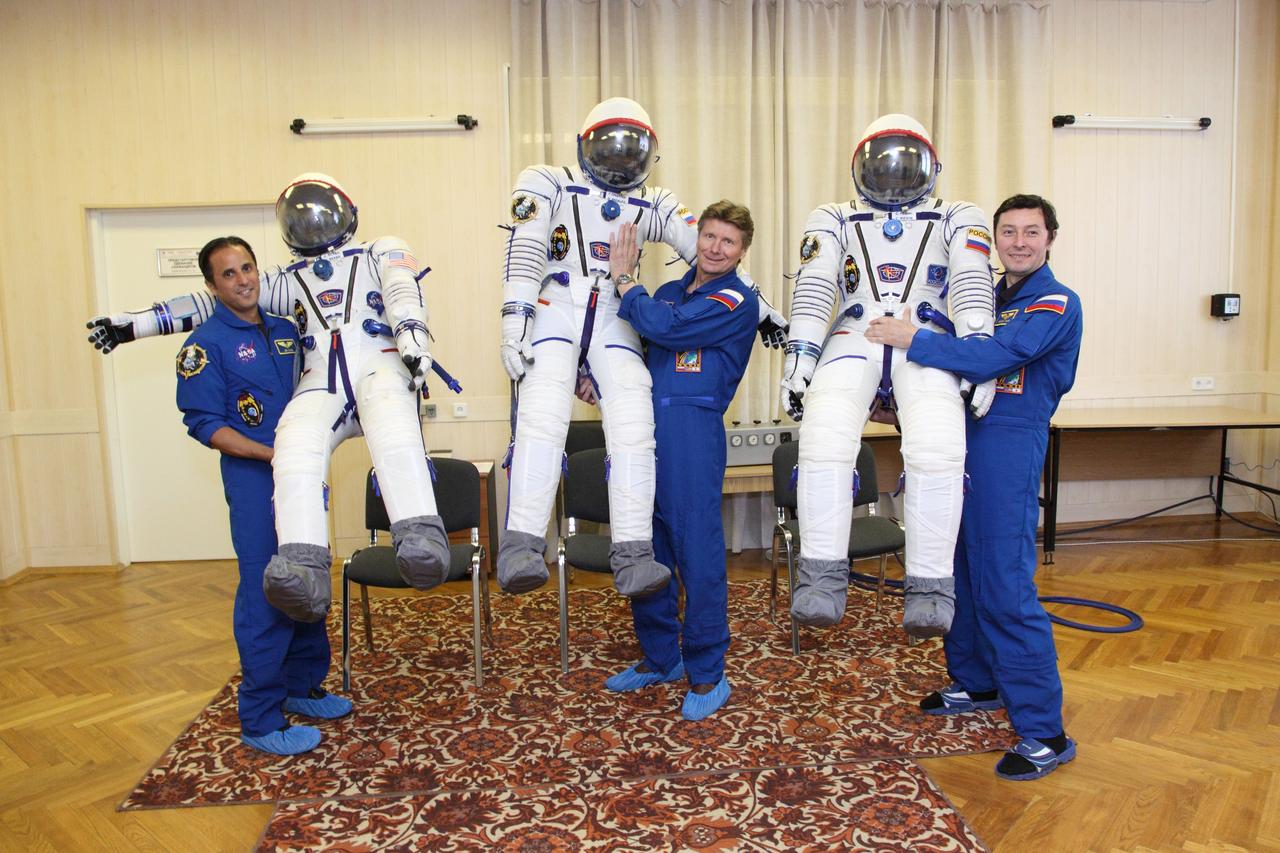 At the Baikonur Cosmodrome in Kazakhstan, Expedition 31/32 Flight Engineer Joe Acaba of NASA (left), Soyuz Commander Gennady Padalka (center) and Flight Engineer Sergei Revin share a light moment as they pose with their “Sokol” launch and entry suits in the Cosmodrome’s integration facility May 3, 2012 during a dress rehearsal of launch day activities in advance of their launch May 15 to the International Space Station. Acaba, Padalka and Revin will spend four months aboard the orbital outpost.  NASA/Victor Zelentsov 