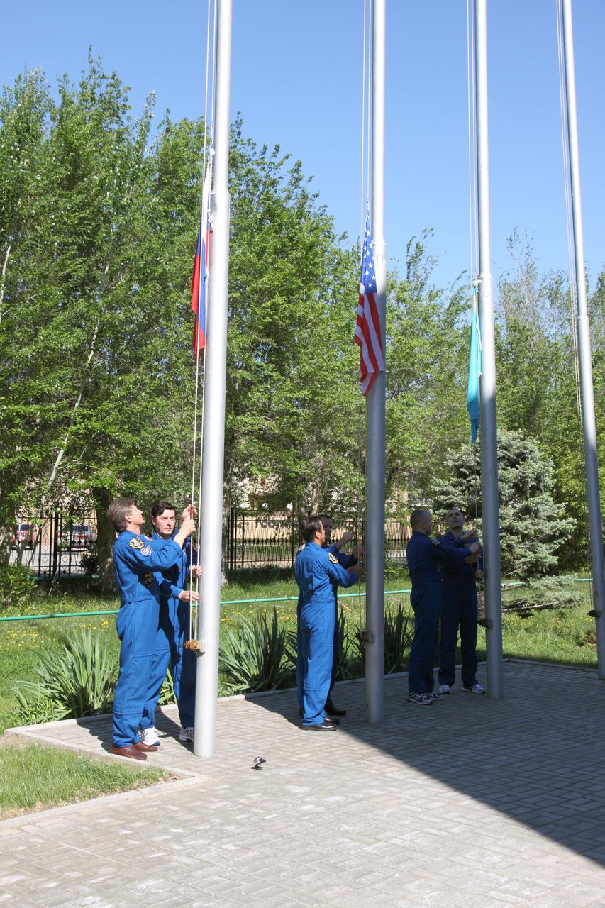 Outside their Cosmonaut Hotel crew quarters in Baikonur, Kazakhstan, the Expedition 31/32 prime and backup crews conducted the traditional raising of Russian, U.S. and Kazakh flags May 4, 2012 as part of their ceremonial activities leading up to the launch of the Soyuz TMA-04M spacecraft May 15 to the International Space Station. From left to right are prime Soyuz Commander Gennady Padalka and Flight Engineer Sergei Revin, prime NASA Flight Engineer Joe Acaba and backup NASA Flight Engineer Kevin Ford and backup Russian crewmembers Oleg Novitskiy and Evgeny Tarelkin. Padalka, Revin and Acaba will launch to the station for a four-month mission on the orbital outpost.  NASA/Victor Zelentsov 