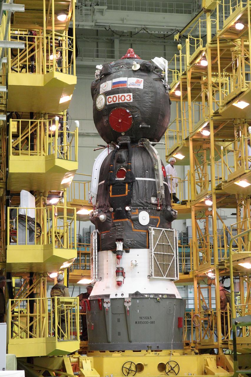 At the Baikonur Cosmodrome in Kazakhstan, the Soyuz TMA-04M spacecraft stands poised in its integration facility May 8, 2012 ready to be enshrouded in the upper stage of the rocket that will launch it and three new crewmembers to the International Space Station. The Soyuz will carry Soyuz Commander Gennady Padalka, NASA Flight Engineer Joe Acaba and Flight Engineer Sergei Revin to the orbital complex on May 15 for a four-month mission. The Soyuz will rollout to its launch pad in Baikonur on May 13.  NASA/Victor Zelentsov 