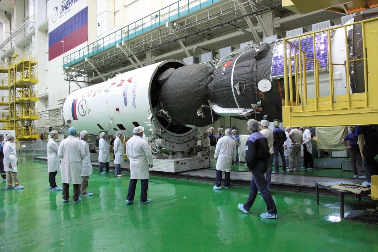 At the Baikonur Cosmodrome in Kazakhstan, technicians monitor the encapsulation of the Soyuz TMA-04M spacecraft into its Soyuz booster upper stage May 8, 2012 in advance of the launching of three new crewmembers to the International Space Station. The Soyuz will carry Soyuz Commander Gennady Padalka, NASA Flight Engineer Joe Acaba and Flight Engineer Sergei Revin to the orbital complex on May 15 for a four-month mission. The Soyuz will rollout to its launch pad in Baikonur on May 13.  NASA/Victor Zelentsov 
