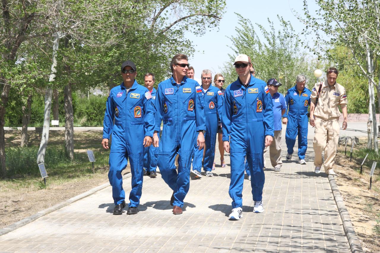 At their Cosmonaut Hotel crew quarters in Baikonur, Kazakhstan, the next trio of crewmembers who will launch to the International Space Station take a traditional stroll down the Walk of the Cosmonauts May 10, 2012 as they take break from final pre-launch training.  From left to right in the foreground are Expedition 31/32 Flight Engineer Joe Acaba of NASA, Soyuz Commander Gennady Padalka and Flight Engineer Sergei Revin, who enjoyed balmy weather as they wrap up preparations for launch May 15 on the Soyuz TMA-04M spacecraft from the Baikonur Cosmodrome to begin a four-month mission on the international outpost.  NASA/Victor Zelentsov 