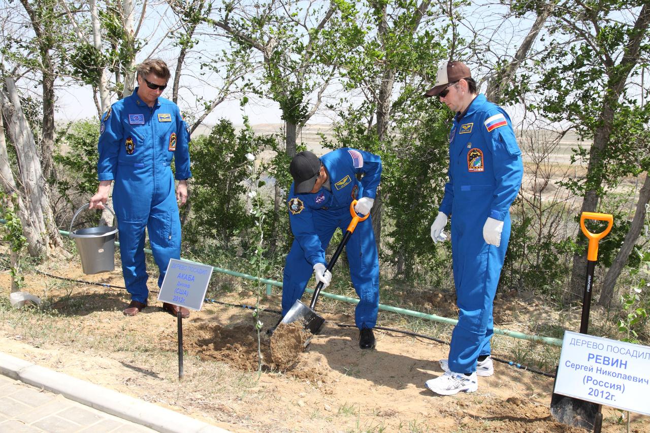 Behind the Cosmonaut Hotel crew quarters in Baikonur, Kazakhstan, Expedition 31/32 Flight Engineer Joe Acaba of NASA (center) plants a tree in his name in a traditional ceremony May 10, 2012 as his crewmates looked on. Acaba will launch on the Soyuz TMA-04M spacecraft on May 15 from the Baikonur Cosmodrome with Soyuz Commander Gennady Padalka (left) and Flight Engineer Sergei Revin (right) for a four-month mission on the International Space Station.  NASA/Victor Zelentsov 