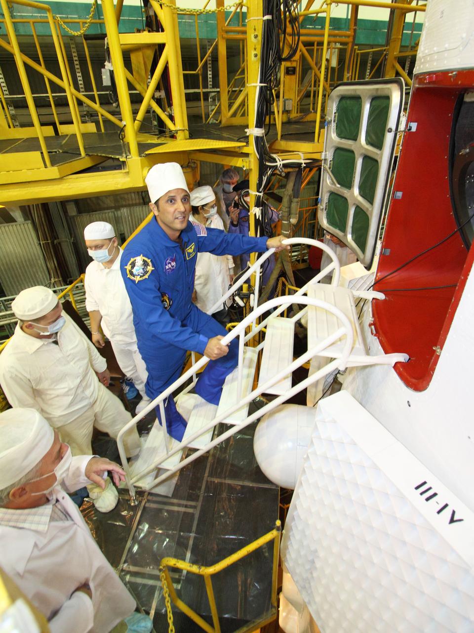 At the Baikonur Cosmodrome in Kazakhstan, Expedition 31/32 Flight Engineer Joe Acaba of NASA boards the Soyuz TMA-04M spacecraft in its assembly building May 11, 2012, as he, Soyuz Commander Gennady Padalka and Flight Engineer Sergei Revin completed their final inspection of the vehicle prior to their launch May 15 to begin a four-months mission on the International Space Station.  NASA/Victor Zelentsov 