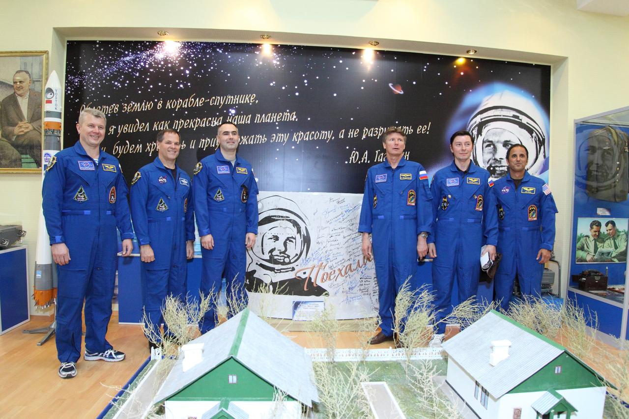 At the historic museum near the launch pad at the Baikonur Cosmodrome in Kazakhstan, the Expedition 31/32 backup and prime crews pose for pictures May 11, 2012 in front of the mural depicting the likeness of Yuri Gagarin, the first human to fly in space. The photo session took place as training for the launch of Soyuz Commander Gennady Padalka, Flight Engineer Joe Acaba of NASA and Flight Engineer Sergei Revin drew to a close for their liftoff May 15 in their Soyuz TMA-04 spacecraft to begin a four-month mission on the International Space Station. From left to right are backup crewmembers Oleg Novitskiy, Kevin Ford of NASA and Evgeny Tarelkin, and the prime crew, Padalka, Revin and Acaba. In the foreground are replicas of the small cottages Gagarin and the Russian space program’s “Great Designer”, Sergei Korolev slept in on the eve of Gagarin’s launch on April 12, 1961. The real cottages are located near the museum in Baikonur.  NASA/Victor Zelentsov 