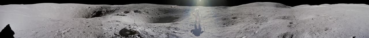 jsc2012e052598 - Panorama view of Apollo 16 lunar surface photos as lunar module pilot Charles M. Duke Jr. is photographed by commander John W. Young collecting lunar samples at Station No. 1 during the first moonwalk of the mission at the Descartes landing site. The panoramas were built by combining Apollo 16 images starting with frame AS16-114-18416 thru end frame AS16-114-18431. The panoramic images received minimal retouching by NASA imagery specialists, including the removal of lens flares that were problematic in stitching together the individual frames and blacking out the sky to the lunar horizon. These adjustments were made based on observations of the Moon walkers who reported that there are no stars visible in the sky due to the bright lunar surface reflection of the Sun. With significant overlap and time delay between frames, it is possible to create two different versions of this panorama with astronaut Charles Duke (Apollo 16) in the center (jsc2012e052598) and both in the center and walking away to the right (jsc2012e052599).