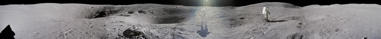 jsc2012e052599 - Panorama view of Apollo 16 lunar surface photos as lunar module pilot Charles M. Duke Jr. is photographed by commander John W. Young collecting lunar samples at Station No. 1 during the first moonwalk of the mission at the Descartes landing site. The panoramas were built by combining Apollo 16 images starting with frame AS16-114-18416 thru end frame AS16-114-18431. The panoramic images received minimal retouching by NASA imagery specialists, including the removal of lens flares that were problematic in stitching together the individual frames and blacking out the sky to the lunar horizon. These adjustments were made based on observations of the Moon walkers who reported that there are no stars visible in the sky due to the bright lunar surface reflection of the Sun. With significant overlap and time delay between frames, it is possible to create two different versions of this panorama with astronaut Charles Duke (Apollo 16) in the center (jsc2012e052598) and both in the center and walking away to the right (jsc2012e052599).
