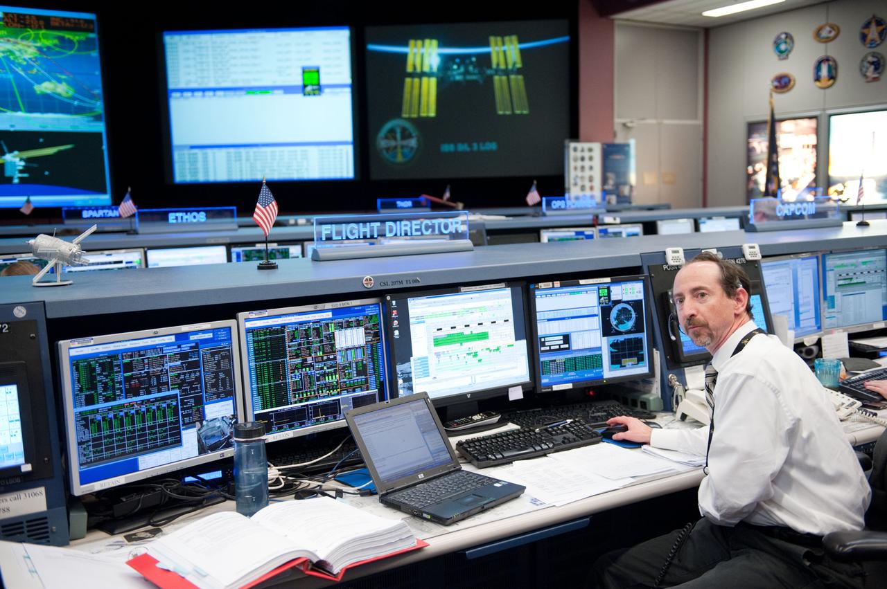 Flight controllers and Flight Director Chris Edelen in the FCR-1 during NASA astronaut Joseph Acaba, flight engineer, and his two Russian crewmates, Soyuz Commander Gennady Padalka and Flight Engineer Sergei Revin, on board the Soyuz TMA-04M spacecraft docking to the space station's Rassvet module at 11:38 p.m.  Photo Date: May 16, 2012.  Location: Building 30 - FCR1.  Photographer: Robert Markowitz
