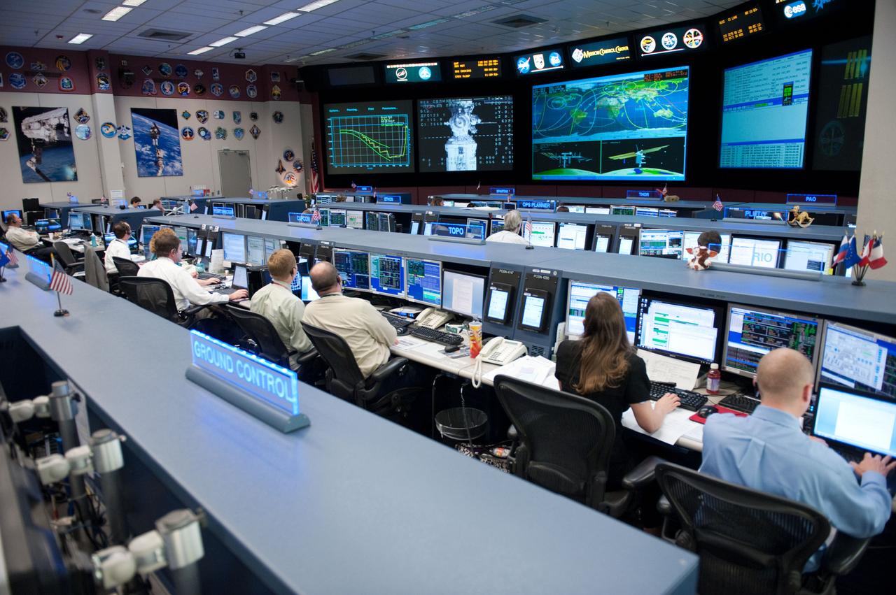 Flight controllers and Flight Director Chris Edelen in the FCR-1 during NASA astronaut Joseph Acaba, flight engineer, and his two Russian crewmates, Soyuz Commander Gennady Padalka and Flight Engineer Sergei Revin, on board the Soyuz TMA-04M spacecraft docking to the space station's Rassvet module at 11:38 p.m.  Photo Date: May 16, 2012.  Location: Building 30 - FCR1.  Photographer: Robert Markowitz