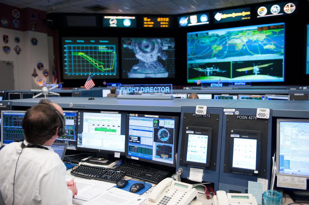 Flight controllers and Flight Director Chris Edelen in the FCR-1 during NASA astronaut Joseph Acaba, flight engineer, and his two Russian crewmates, Soyuz Commander Gennady Padalka and Flight Engineer Sergei Revin, on board the Soyuz TMA-04M spacecraft docking to the space station's Rassvet module at 11:38 p.m.  Photo Date: May 16, 2012.  Location: Building 30 - FCR1.  Photographer: Robert Markowitz