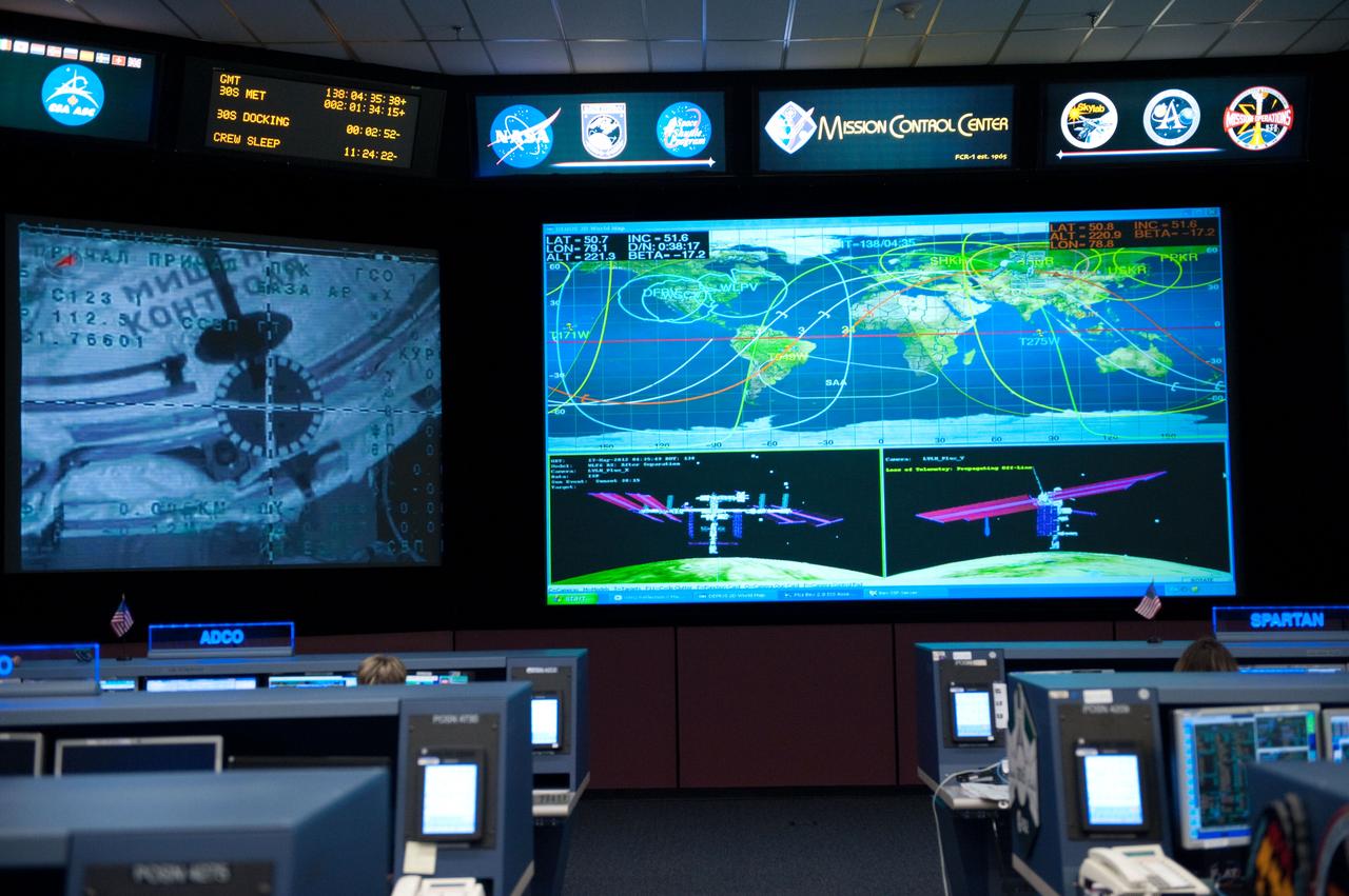 Flight controllers and Flight Director Chris Edelen in the FCR-1 during NASA astronaut Joseph Acaba, flight engineer, and his two Russian crewmates, Soyuz Commander Gennady Padalka and Flight Engineer Sergei Revin, on board the Soyuz TMA-04M spacecraft docking to the space station's Rassvet module at 11:38 p.m.  Photo Date: May 16, 2012.  Location: Building 30 - FCR1.  Photographer: Robert Markowitz