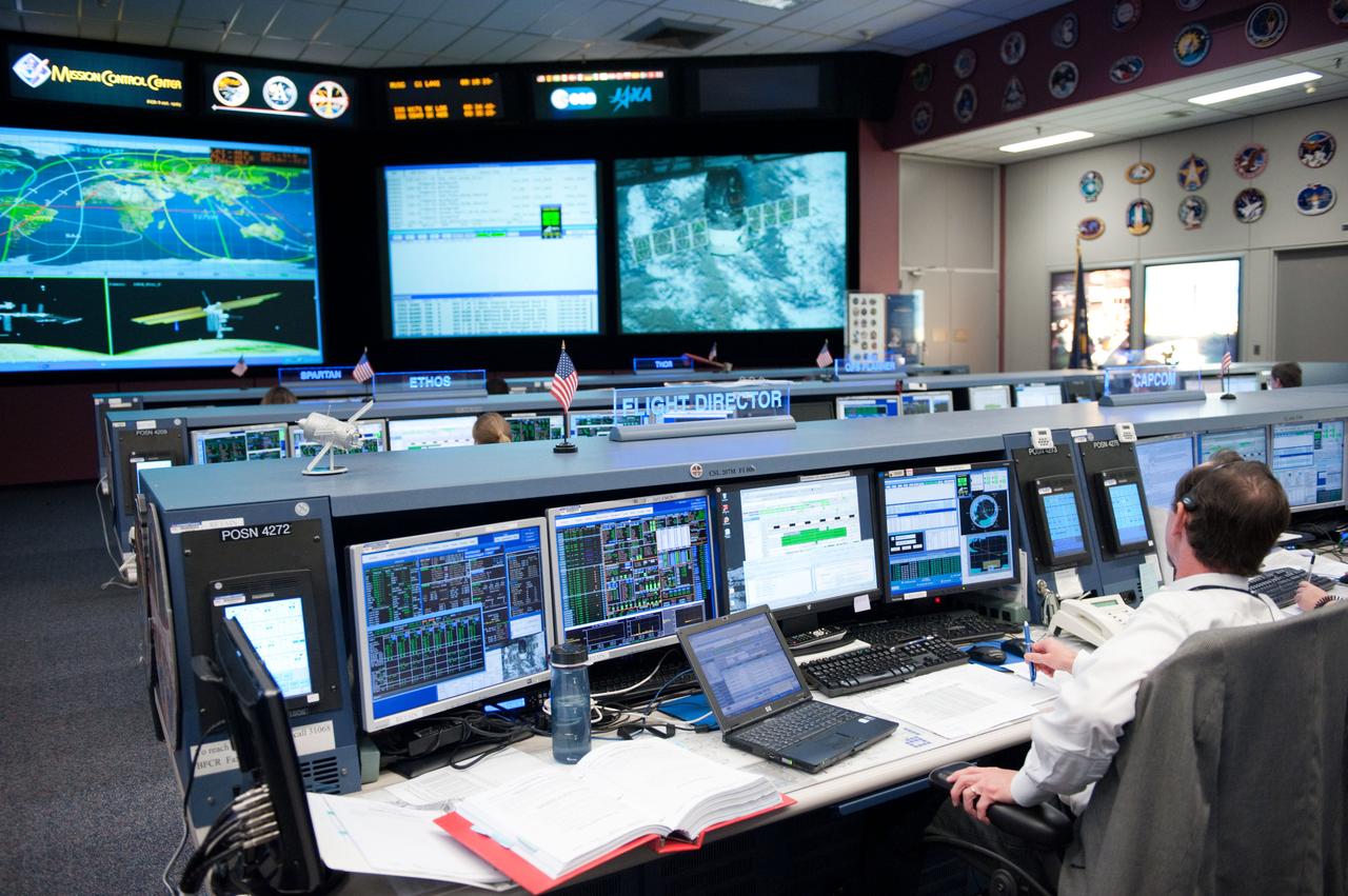 Flight controllers and Flight Director Chris Edelen in the FCR-1 during NASA astronaut Joseph Acaba, flight engineer, and his two Russian crewmates, Soyuz Commander Gennady Padalka and Flight Engineer Sergei Revin, on board the Soyuz TMA-04M spacecraft docking to the space station's Rassvet module at 11:38 p.m.  Photo Date: May 16, 2012.  Location: Building 30 - FCR1.  Photographer: Robert Markowitz