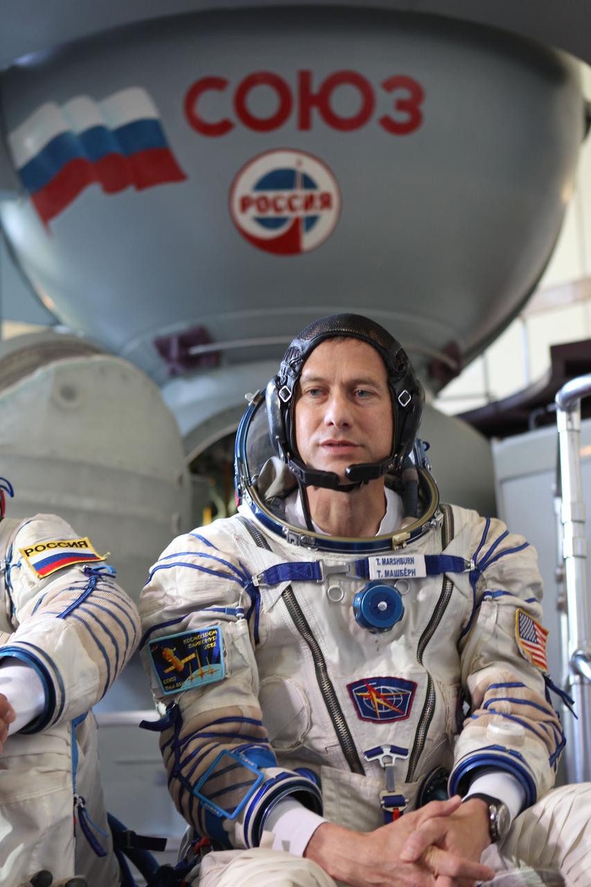 (19 June 2012) --- Expedition 32/33 backup crew member Tom Marshburn of NASA answers questions from the media at a Soyuz vehicle mockup before a final qualification test June 19, 2012 at the Gagarin Cosmonaut Training Center in Star City, Russia. Marshburn’s colleagues, prime crew members Expedition 32/33 Soyuz Commander Yuri Malenchenko and Flight Engineers Suni Williams of NASA and Aki Hoshide of the Japan Aerospace Exploration Agency practiced similar scenarios nearby in advance of their final approval for launch to the International Space Station July 15 in their Soyuz TMA-05M spacecraft. Photo credit: NASA 