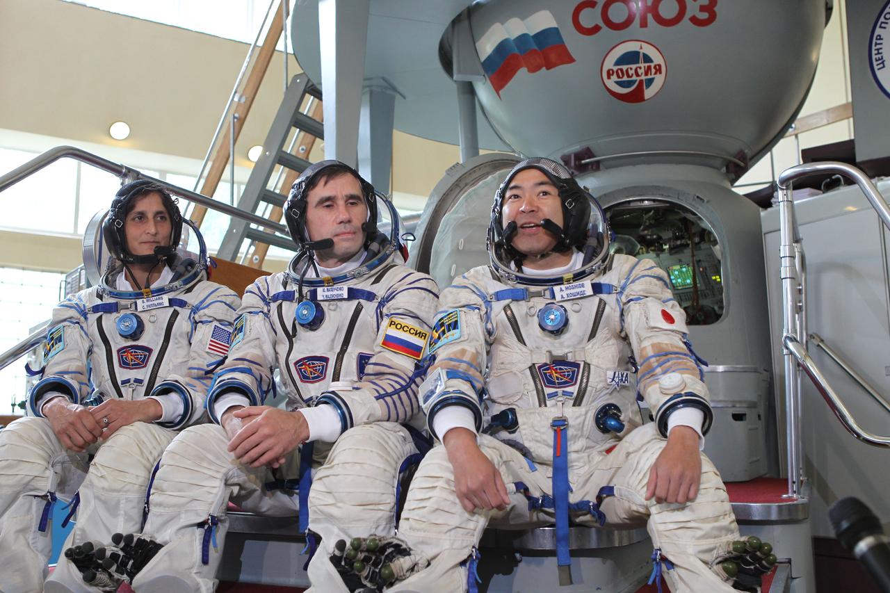 (20 June 2012) --- Expedition 32/33 NASA Flight Engineer Sunita Williams of NASA (left), Soyuz Commander Yuri Malenchenko (center), and Japan Aerospace Exploration Agency Flight Engineer Aki Hoshide (right), answer questions from the media at a Soyuz vehicle mock-up before their final qualification test June 20, 2012 at the Gagarin Cosmonaut Training Center in Star City, Russia. Malenchenko, Williams and Hoshide are scheduled to launch July 15 from the Baikonur Cosmodrome in their Soyuz TMA-05M spacecraft to the International Space Station.  Photo credit: NASA/Stephanie Stoll 