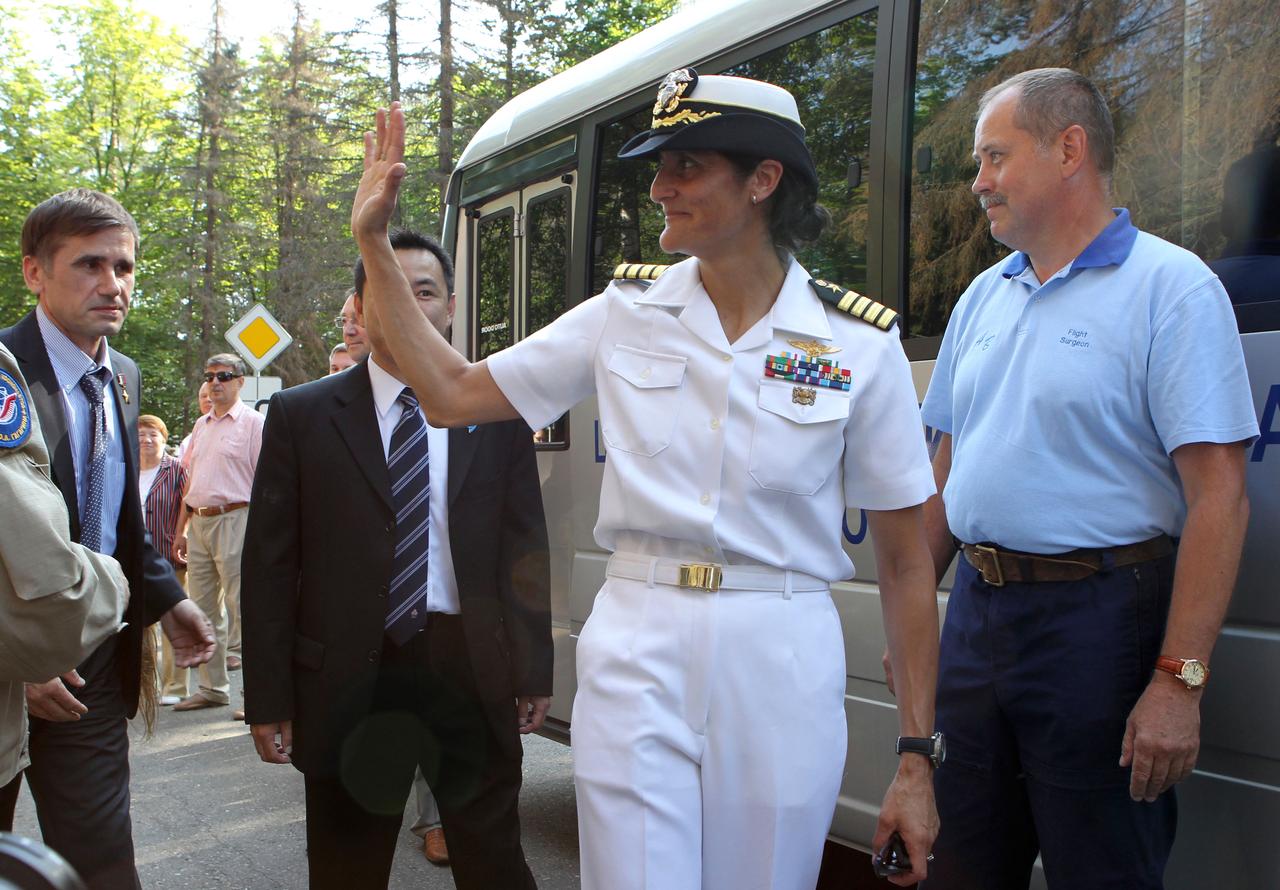 (2 July 2012) --- At the Gagarin Cosmonaut Training Center at Star City, Russia on July 2, 2012, Expedition 32 NASA Flight Engineer Sunita Williams waves goodbye prior to boarding a bus for a flight that would take her and her Expedition 32 crewmates -- Japan Aerospace Exploration Agency Flight Engineer Aki Hoshide and Soyuz Commander Yuri Malenchenko (background left) - to the Baikonur Cosmodrome in Kazakhstan for final preparations for their launch to the International Space Station on July 15 (Kazakhstan time) in their Soyuz TMA-05M spacecraft from Baikonur.  NASA/Stephanie Stoll  
