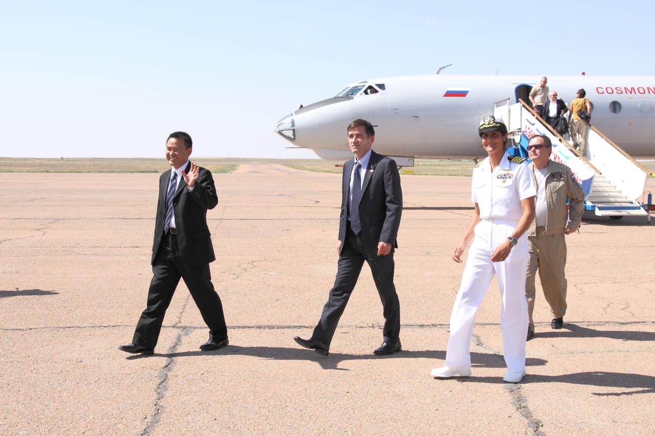 Expedition 32 Flight Engineer Aki Hoshide of the Japan Aerospace Exploration Agency (left), Soyuz Commander Yuri Malenchenko (center) and NASA Flight Engineer Sunita Williams (right) arrive at the Baikonur Cosmodrome in Kazakhstan July 2, 2012 after a flight from their training base in Star City, Russia for final pre-launch preparations. The trio will be launched July 15 from Baikonur to the International Space Station in their Soyuz TMA-05 spacecraft for a four-month mission.  NASA/Victor Zelentsov 