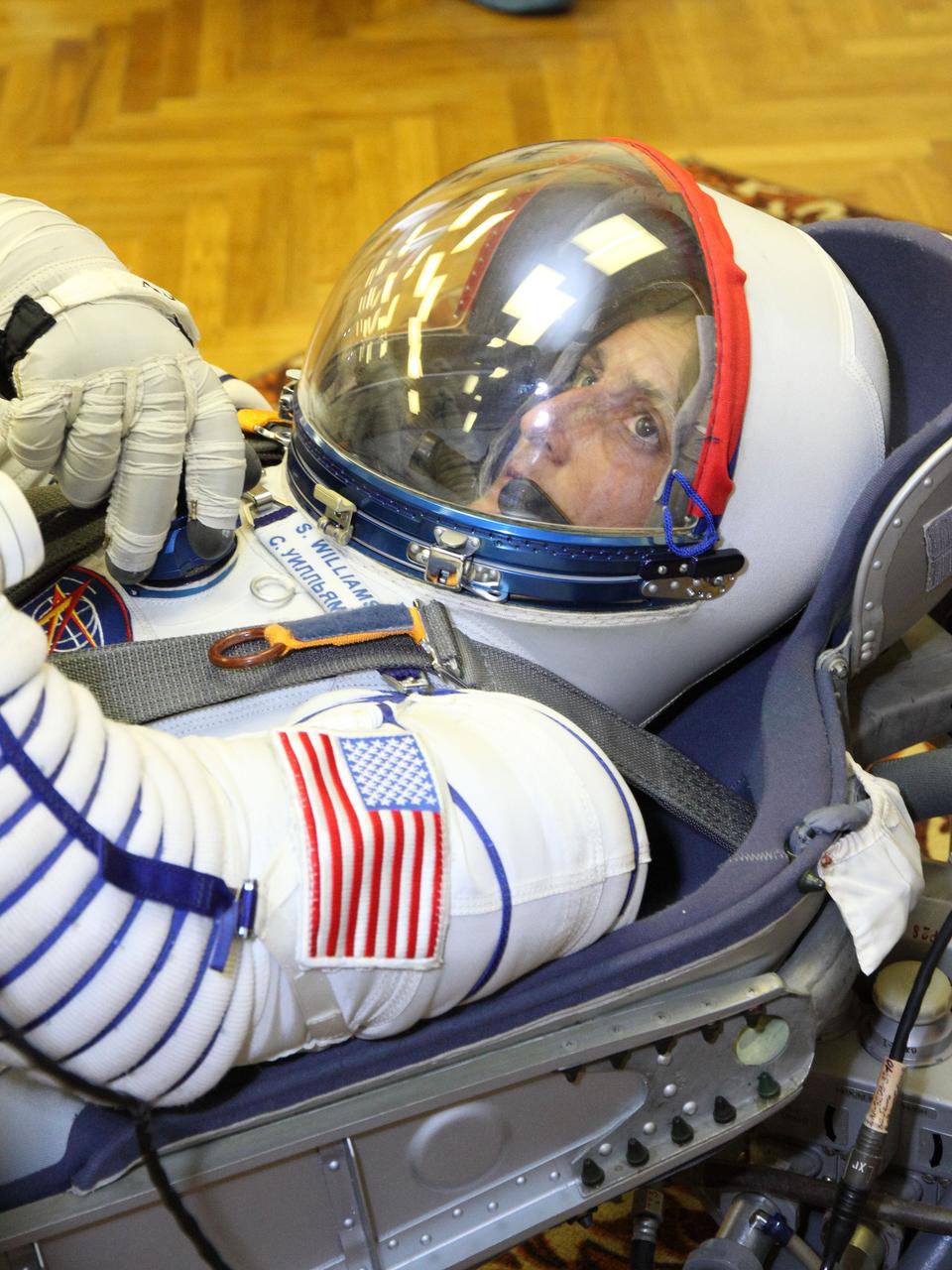 At the Baikonur Cosmodrome in Kazakhstan, Expedition 32/33 Flight Engineer Sunita Williams rests during a leak check of her Russian launch and entry suit July 3, 2012 as part of the suited “fit check” of the Soyuz TMA-05M spacecraft that will launch her, Soyuz Commander Yuri Malenchenko and Flight Engineer Aki Hoshide of the Japan Aerospace Exploration Agency to the International Space Station on July 15.  NASA/Victor Zelentsov 