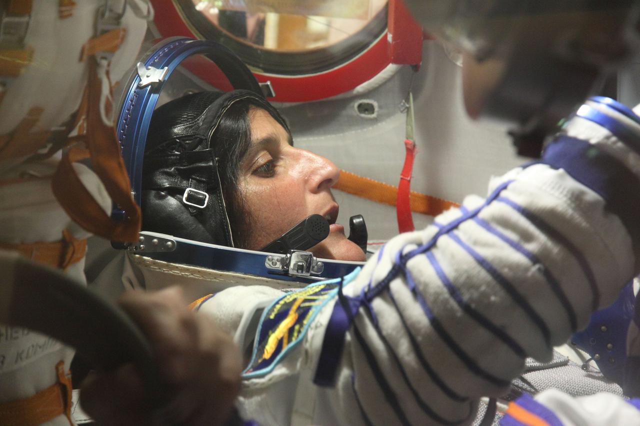 At the Baikonur Cosmodrome in Kazakhstan, Expedition 32/33 Flight Engineer Sunita Williams of NASA works through procedures in the Soyuz TMA-05M spacecraft July 3, 2012 during a suited “fit check” of the vehicle in which she, Soyuz Commander Yuri Malenchenko and Flight Engineer Aki Hoshide of the Japan Aerospace Exploration Agency will launch July 15 to the International Space Station.  NASA/Victor Zelentsov 