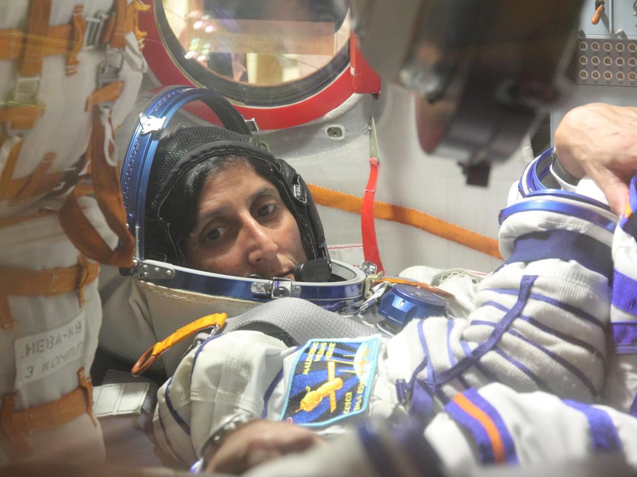 At the Baikonur Cosmodrome in Kazakhstan, Expedition 32/33 Flight Engineer Sunita Williams of NASA works through procedures in the Soyuz TMA-05M spacecraft July 3, 2012 during a suited “fit check” of the vehicle in which she, Soyuz Commander Yuri Malenchenko and Flight Engineer Aki Hoshide of the Japan Aerospace Exploration Agency will launch July 15 to the International Space Station.  NASA/Victor Zelentsov 