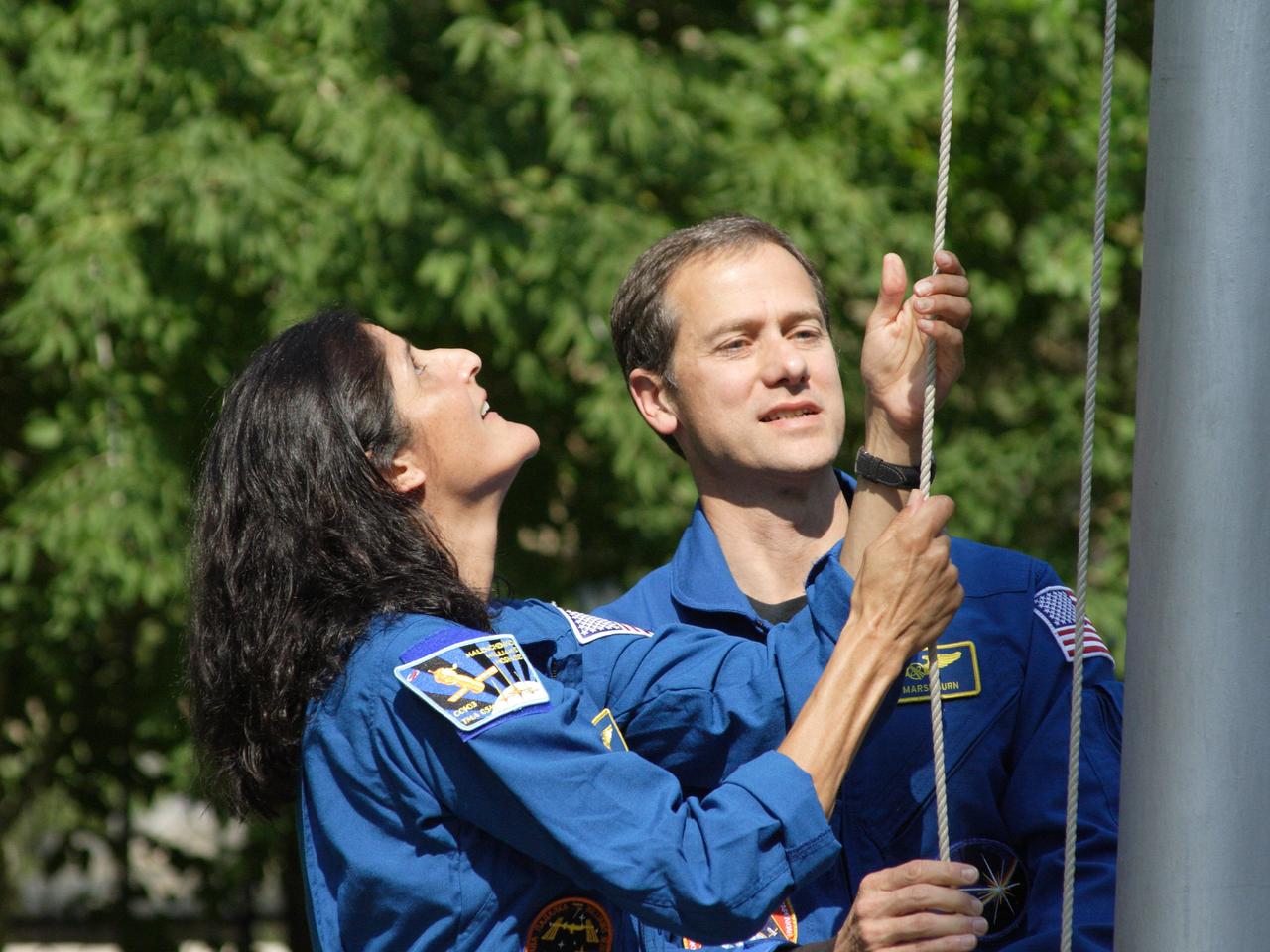Outside their Cosmonaut Hotel crew quarters in Baikonur, Kazakhstan, Expedition 32 prime crew member Flight Engineer Sunita Williams of NASA (left) and backup Flight Engineer Tom Marshburn of NASA (right) raise the Stars and Stripes on the 4th of July, 2012 in a traditional flag-raising ceremony that was part of the pre-launch activities leading up to the launch of the next crew to the International Space Station. Williams, Soyuz Commander Yuri Malenchenko and Flight Engineer Aki Hoshide of the Japan Aerospace Exploration Agency will launch to the station July 15 from the Baikonur Cosmodrome in their Soyuz TMA-05M spacecraft.  NASA/Victor Zelentsov 
