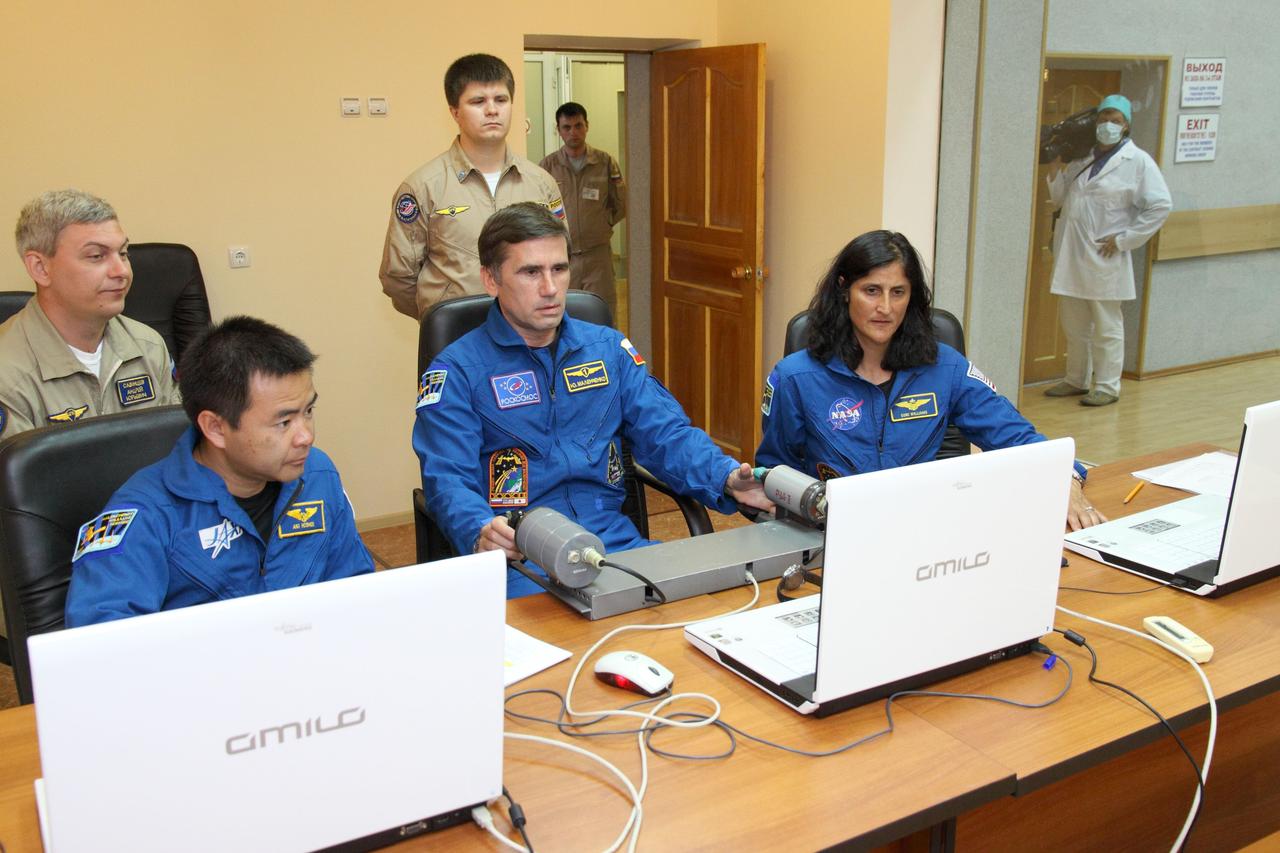 At their Cosmonaut Hotel crew quarters in Baikonur, Kazakhstan, the Expedition 32/33 prime crew members participate in a rendezvous and docking practice session using laptop computer simulators July 9, 2012 as they prepare for their launch July 15 to the International Space Station in their Soyuz TMA-05M spacecraft. From left to right with their instructors are Flight Engineer Aki Hoshide of the Japan Aerospace Exploration Agency, Soyuz Commander Yuri Malenchenko and NASA Flight Engineer Sunita Williams.  NASA/Victor Zelentsov 