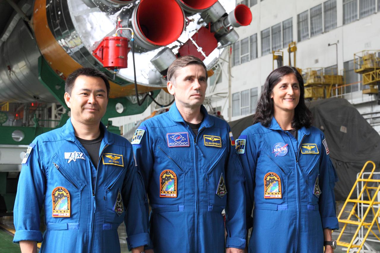 At the the Baikonur Cosmodrome in Kazakhstan, the Expedition 32/33 crewmembers pose for pictures in front of the engines of the first stage of their Soyuz booster rocket July 10, 2012 following a final check of the Soyuz TMA-05M vehicle they will launch in July 15 to the International Space Station. From left to right are Flight Engineer Aki Hoshide of the Japan Aerospace Exploration Agency, Soyuz Commander Yuri Malenchenko and NASA Flight Engineer Sunita Williams.  NASA/Victor Zelentsov 