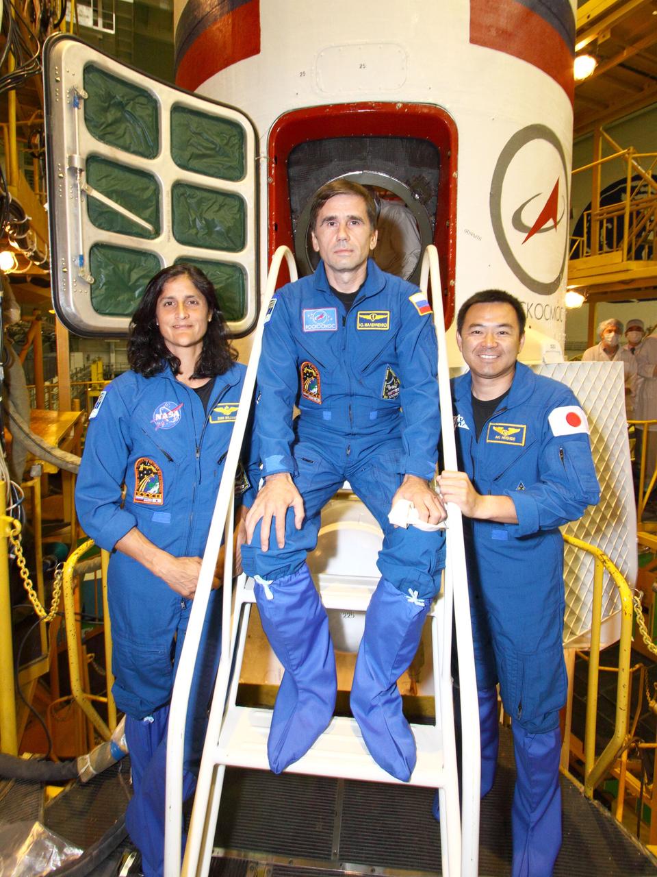 At the the Baikonur Cosmodrome in Kazakhstan, the Expedition 32/33 crewmembers pose for pictures at the hatchway of their Soyuz TMA-05M spacecraft July 10, 2012 following a final check of the vehicle as they prepare for launch July 15 to the International Space Station. From left to right are NASA Flight Engineer Sunita Williams, Soyuz Commander Yuri Malenchenko and Flight Engineer Aki Hoshide of the Japan Aerospace Exploration Agency.  NASA/Victor Zelentsov 