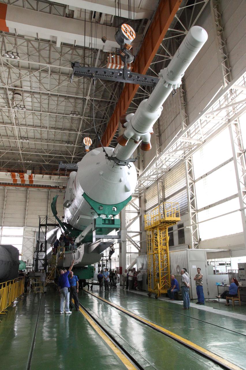 The Soyuz TMA-05M spacecraft and booster are seen at the Integration Facility at the Baikonur Cosmodrome in Kazakhstan July 11, 2012 following the mating of the upper stages of the vehicle to the first stage as preparations continued for the launch July 15 of Expedition 32/33 Soyuz Commander Yuri Malenchenko, NASA Flight Engineer Sunita Williams and Flight Engineer Aki Hoshide of the Japan Aerospace Exploration Agency to the International Space Station.   NASA/Victor Zelentsov 