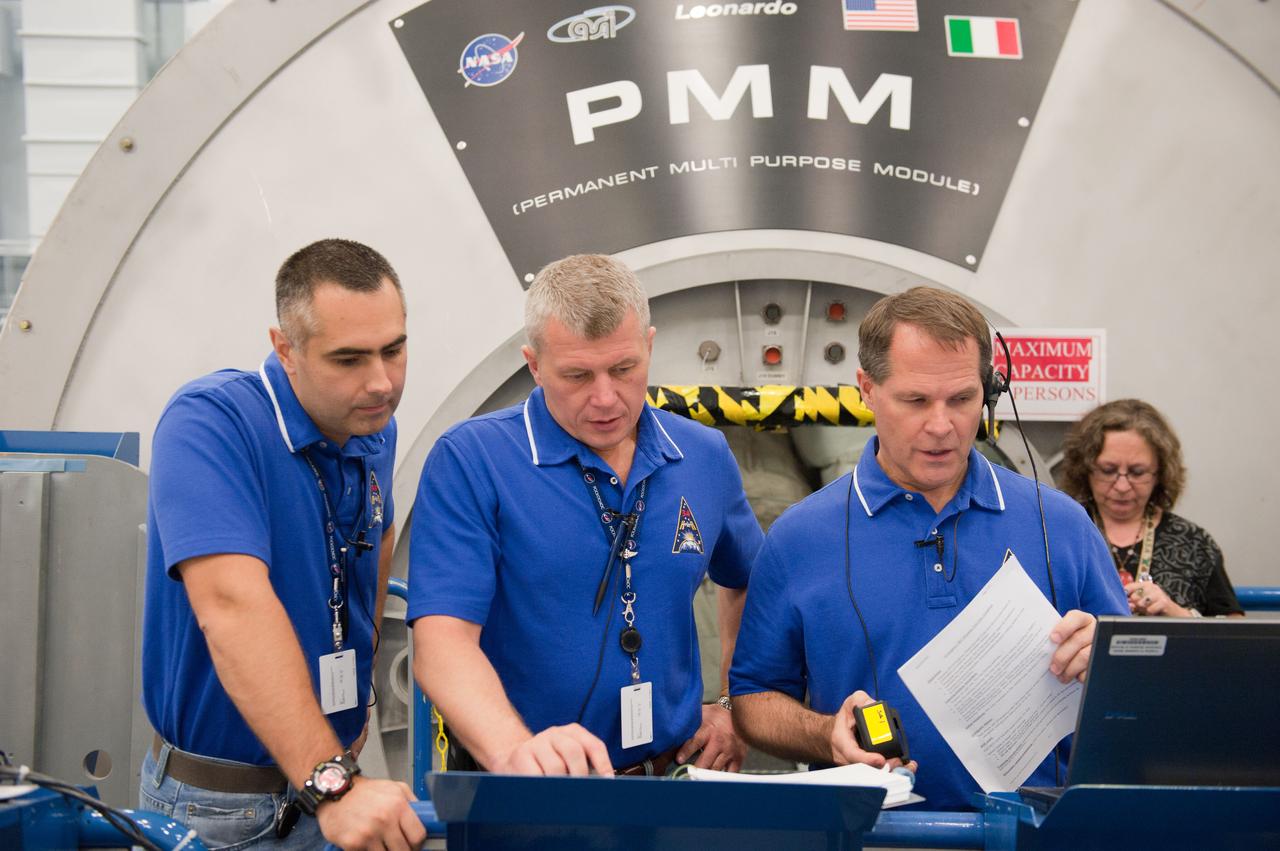 PHOTO DATE: 7-20-12 LOCATION: Bldg. 9NW - ISS Mockups SUBJECT: Expedition 34 (Soyuz 32) crew (Ford, Tarelkin and Notivskiy) during routine ops training in the ISS mockups PHOTOGRAPHER: Lauren Harnett