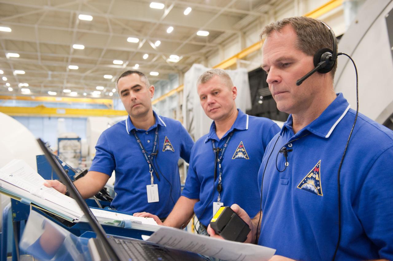PHOTO DATE: 7-20-12 LOCATION: Bldg. 9NW - ISS Mockups SUBJECT: Expedition 34 (Soyuz 32) crew (Ford, Tarelkin and Notivskiy) during routine ops training in the ISS mockups PHOTOGRAPHER: Lauren Harnett