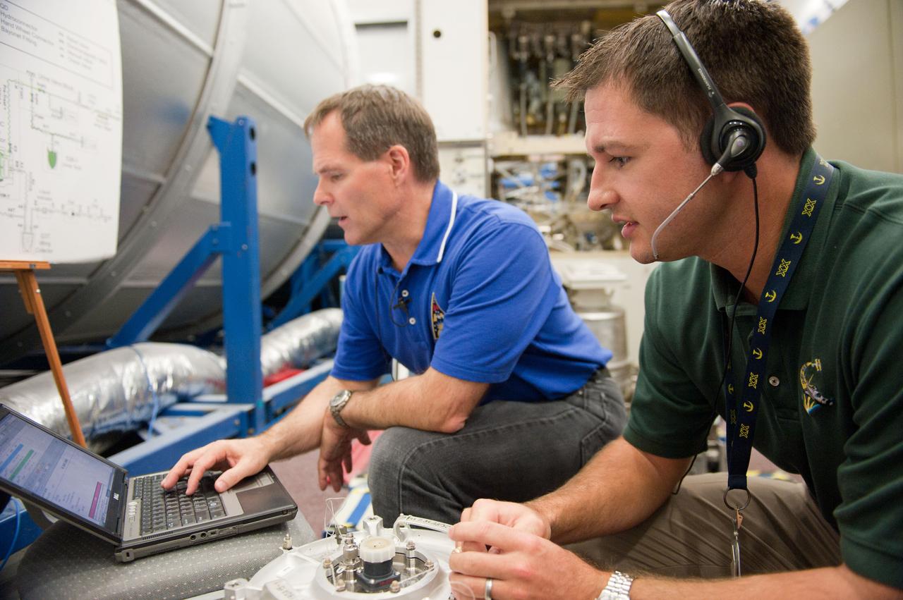 PHOTO DATE: 7-20-12 LOCATION: Bldg. 9NW - ISS Mockups SUBJECT: Expedition 34 (Soyuz 32) crew (Ford, Tarelkin and Notivskiy) during routine ops training in the ISS mockups PHOTOGRAPHER: Lauren Harnett