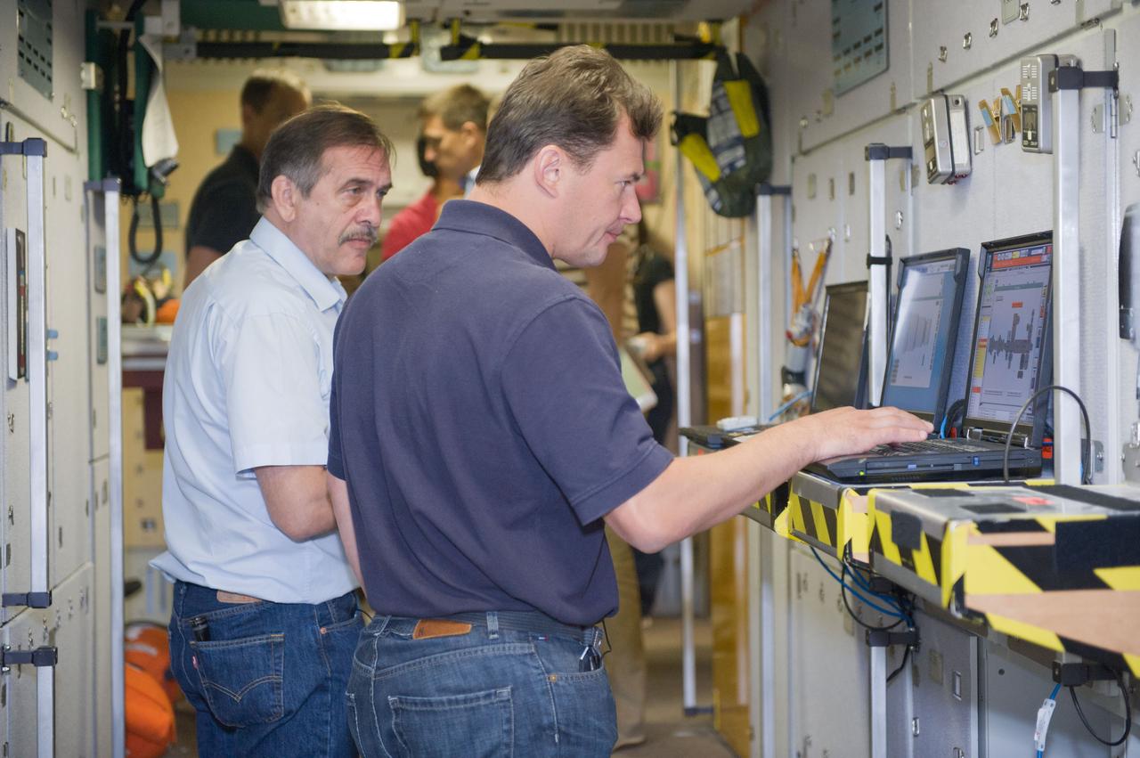 JSC2012-E-108016 (2 Aug. 2012) --- Russian cosmonauts Pavel Vinogradov (left), Expedition 35 flight engineer and Expedition 36 commander, and Roman Romanenko, Expedition 34/35 flight engineer, participate in an emergency scenario training session in an International Space Station mock-up/trainer in the Space Vehicle Mock-up Facility at NASA's Johnson Space Center. Photo credit: NASA