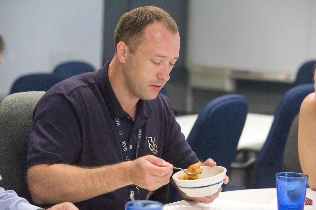 PHOTO DATE: 01 August 2012 LOCATION: Bldg. 17 - JSC Food Lab SUBJECT: Expedition 35/36 Russian cosmonauts during food tasting in JSC Food Lab. Vinogradov, Yurchikin and Misurkin with Russian interpreter. PHOTOGRAPHER: Mark Sowa