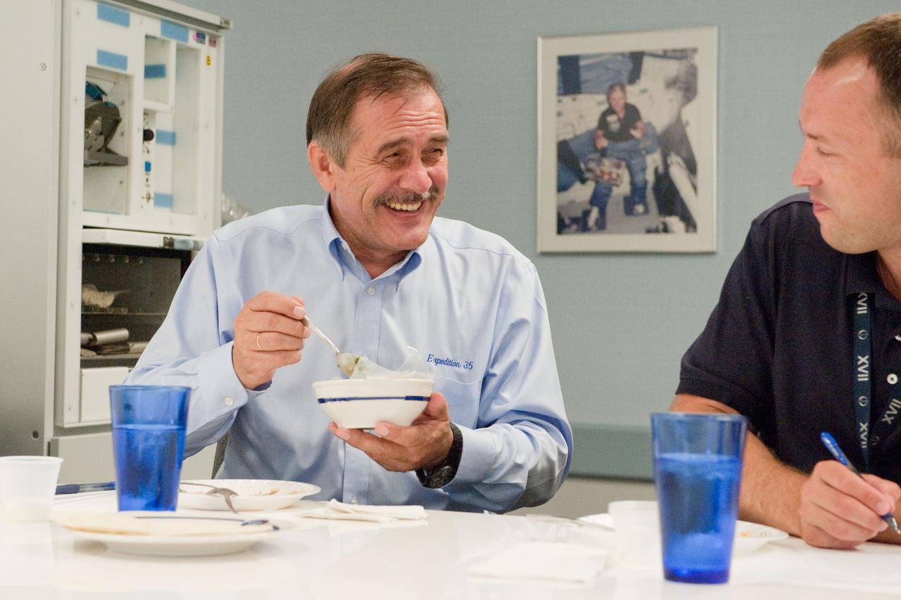 PHOTO DATE: 01 August 2012 LOCATION: Bldg. 17 - JSC Food Lab SUBJECT: Expedition 35/36 Russian cosmonauts during food tasting in JSC Food Lab. Vinogradov, Yurchikin and Misurkin with Russian interpreter. PHOTOGRAPHER: Mark Sowa