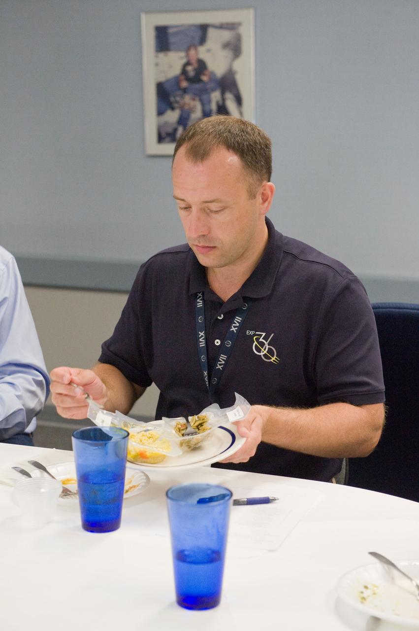 PHOTO DATE: 01 August 2012 LOCATION: Bldg. 17 - JSC Food Lab SUBJECT: Expedition 35/36 Russian cosmonauts during food tasting in JSC Food Lab. Vinogradov, Yurchikin and Misurkin with Russian interpreter.  PHOTOGRAPHER: Mark Sowa
