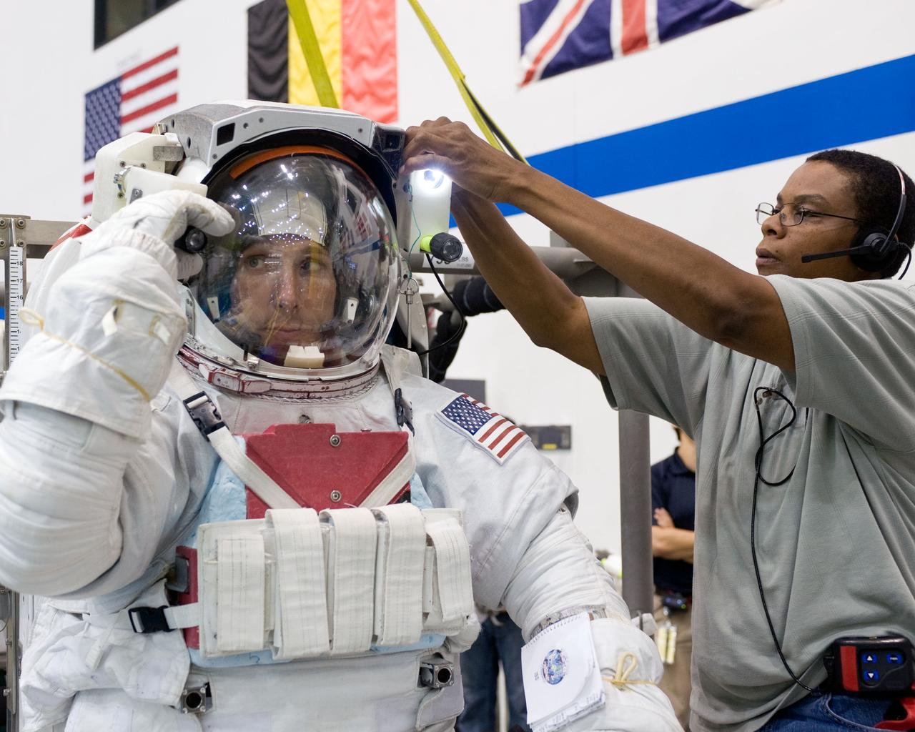 PHOTO DATE:  08-15-12 LOCATION:NBL - Pool Topside    SUBJECT: Expedition 38/39 crew members Koichi Wakata and Mike Hopkins getting suited up and prepped for ISS EVA Maintenance training at the NBL.  PHOTOGRAPHER: BILL STAFFORD