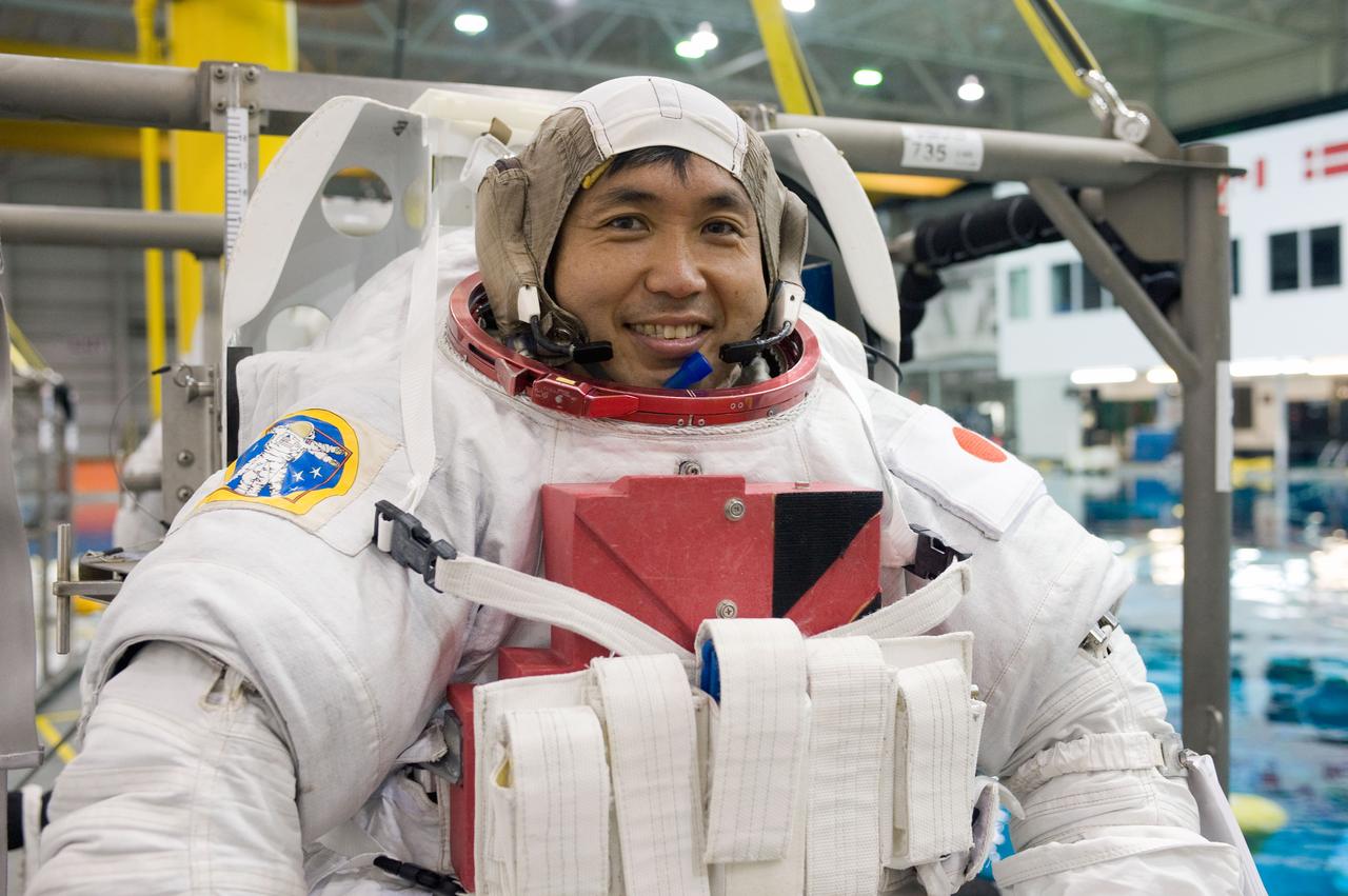 PHOTO DATE:  08-15-12 LOCATION:NBL - Pool Topside    SUBJECT: Expedition 38/39 crew members Koichi Wakata and Mike Hopkins getting suited up and prepped for ISS EVA Maintenance training at the NBL.  PHOTOGRAPHER: BILL STAFFORD