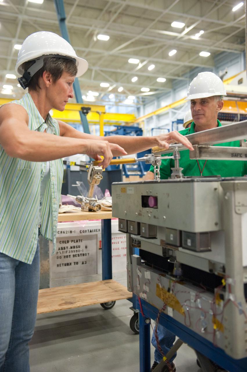 PHOTO DATE:  09-01-12 LOCATION:   Bldg 9NW, POGO SUBJECT: Photograph EVA/MOD personnel and engineers working ISS EVA issue in preparation for unscheduled EVA PHOTOGRAPHER: Lauren Harnett