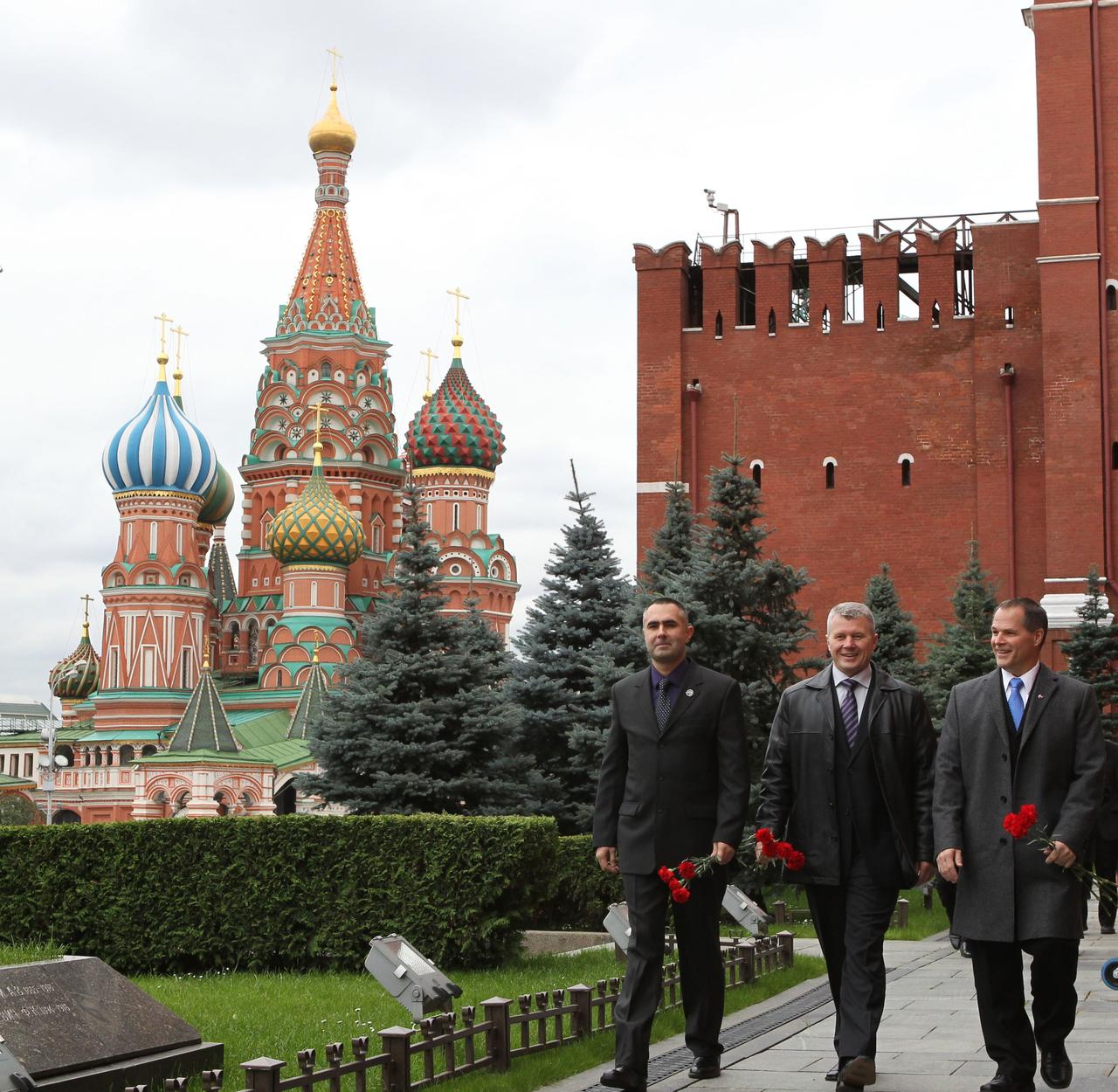 With St. Basil’s Cathedral providing a fitting backdrop, the Expedition 33/34 prime crewmembers arrive at the Kremlin Wall in Moscow’s Red Square September 25, 2012 to conduct the traditional laying of flowers at the site where Russian space icons are interred, including Yuri Gagarin, the first human to fly in space, and Sergei Korolev, Russia’s Great Designer. From left to right are Russian Flight Engineer Evgeny Tarelkin, Soyuz Commander Oleg Novitskiy and NASA Flight Engineer Kevin Ford. The trio will launch October 23 from the Baikonur Cosmodrome in Kazakhstan in their Soyuz TMA-06M spacecraft for a five-month mission on the International Space Station. NASA/Stephanie Stoll 