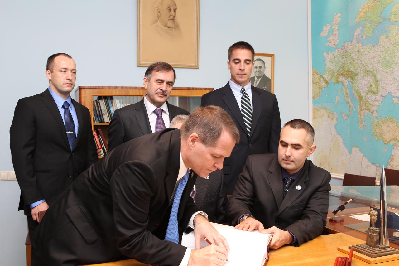 At Yuri Gagarin’s museum at the Gagarin Cosmonaut Training Center in Star City, Russia, Expedition 33/34 Flight Engineer Kevin Ford of NASA signs a commemorative book September 25, 2012 as one of his crewmates, Flight Engineer Evgeny Tarelkin (right), and backup crewmembers Alexander Misurkin, Pavel Vinogradov and Chris Cassidy of NASA (left to right in the rear) look on. Ford, Tarelkin and Soyuz Commander Oleg Novitskiy are the homestretch of their training for launch October 23 to the International Space Station from the Baikonur Cosmodrome in Kazakhstan on their Soyuz TMA-06M spacecraft. The trio will spend five months on the orbital outpost. NASA/Stephanie Stoll