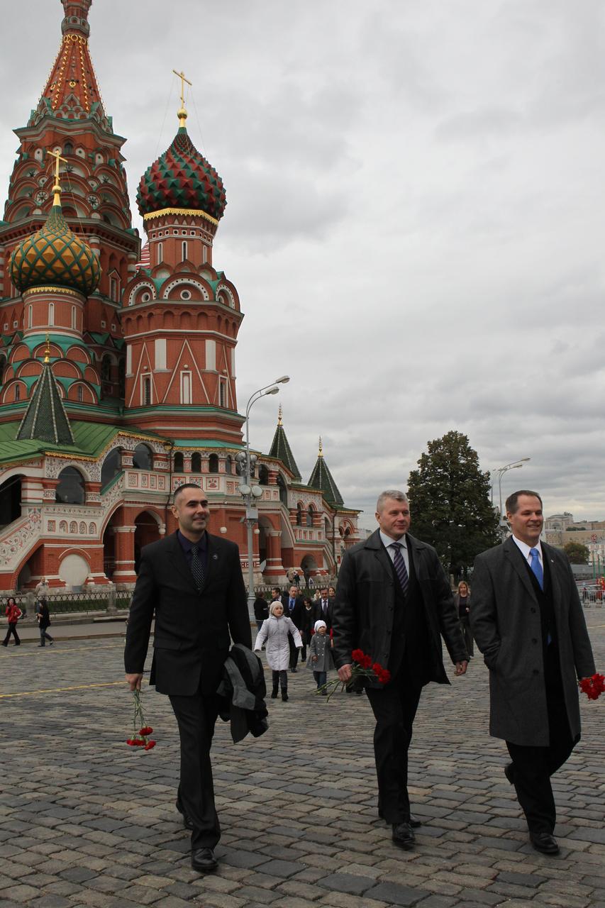 With St. Basil’s Cathedral serving as a scenic backdrop, Expedition 33/34 Flight Engineer Evgeny Tarelkin (left), Soyuz Commander Oleg Novitskiy (center) and NASA Flight Engineer Kevin Ford (right) walk through Red Square in Moscow September 25, 2012 to participate in traditional ceremonies and the laying of flowers at the Kremlin Wall where Russian space icons are interred. The trio are scheduled to launch October 23 to the International Space Station from the Baikonur Cosmodrome in Kazakhstan on their Soyuz TMA-06M spacecraft for a five-month mission. NASA/Stephanie Stoll