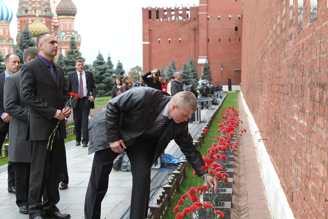 Expedition 33/34 Soyuz Commander Oleg Novitskiy plants a flower at the Kremlin Wall in Moscow where Russian space icons are interred September 25, 2012 as he, Flight Engineer Evgeny Tarelkin (left) and NASA Flight Engineer Kevin Ford (hidden behind Tarelkin) participated in traditional ceremonies leading to their launch to the International Space Station October 23 in the Soyuz TMA-06M spacecraft from the Baikonur Cosmodrome in Kazakhstan for a five-month mission. NASA/Stephanie Stoll
